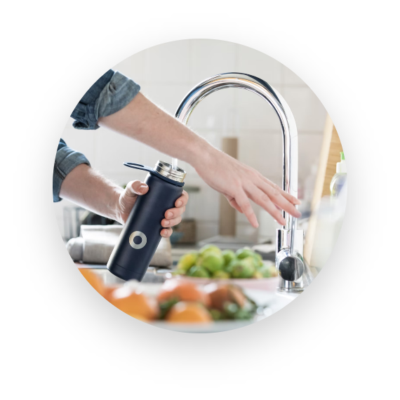 UNISUS Green Energy｜A Resident Fills A Black Bottle with District Drinking Water from An In-room Smart Faucet