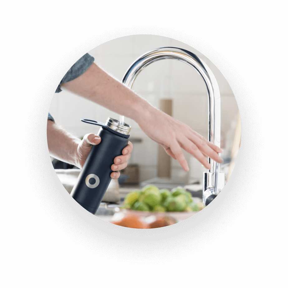 UNISUS Green Energy｜A Resident Fills A Black Bottle with District Drinking Water from An In-room Smart Faucet